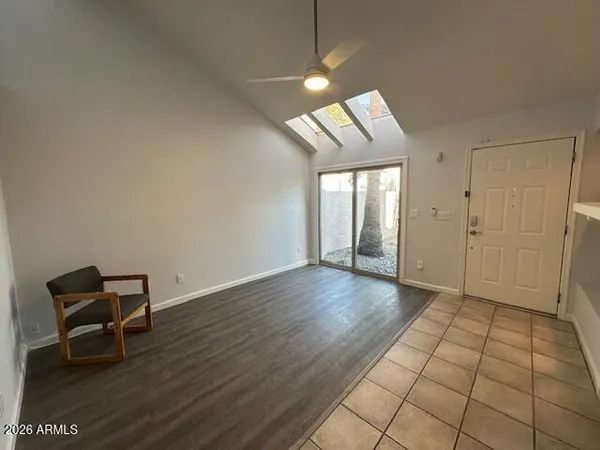 a view of a room with wooden floor and furniture