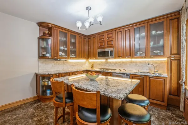a kitchen with granite countertop sink cabinets and wooden floor