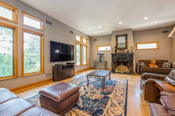 a living room with furniture a flat screen tv and a large window