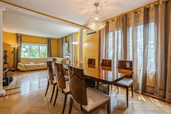 a view of a dining room with furniture window and wooden floor