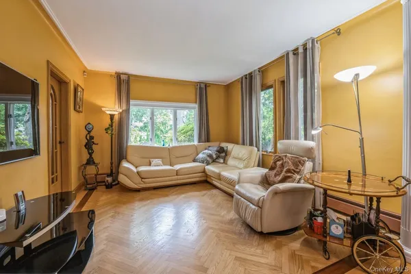 a living room with furniture and large windows