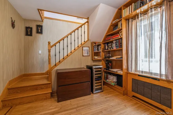 a view of staircase with wooden floor and windows