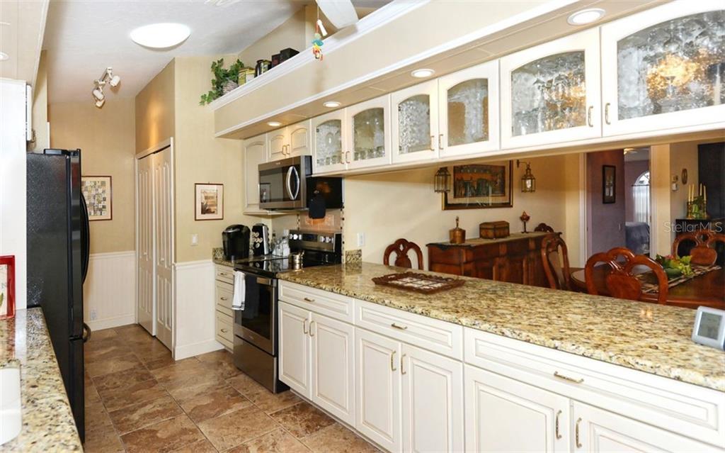 275 Woods Point Road Osprey, FL 34229 - Photo 12 of 40 Renovated Kitchen opening to great room dining area.