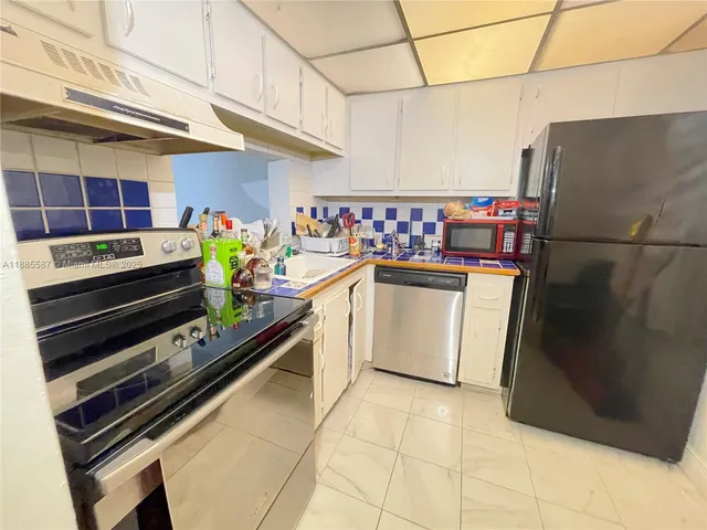 a kitchen with stainless steel appliances a stove and a refrigerator