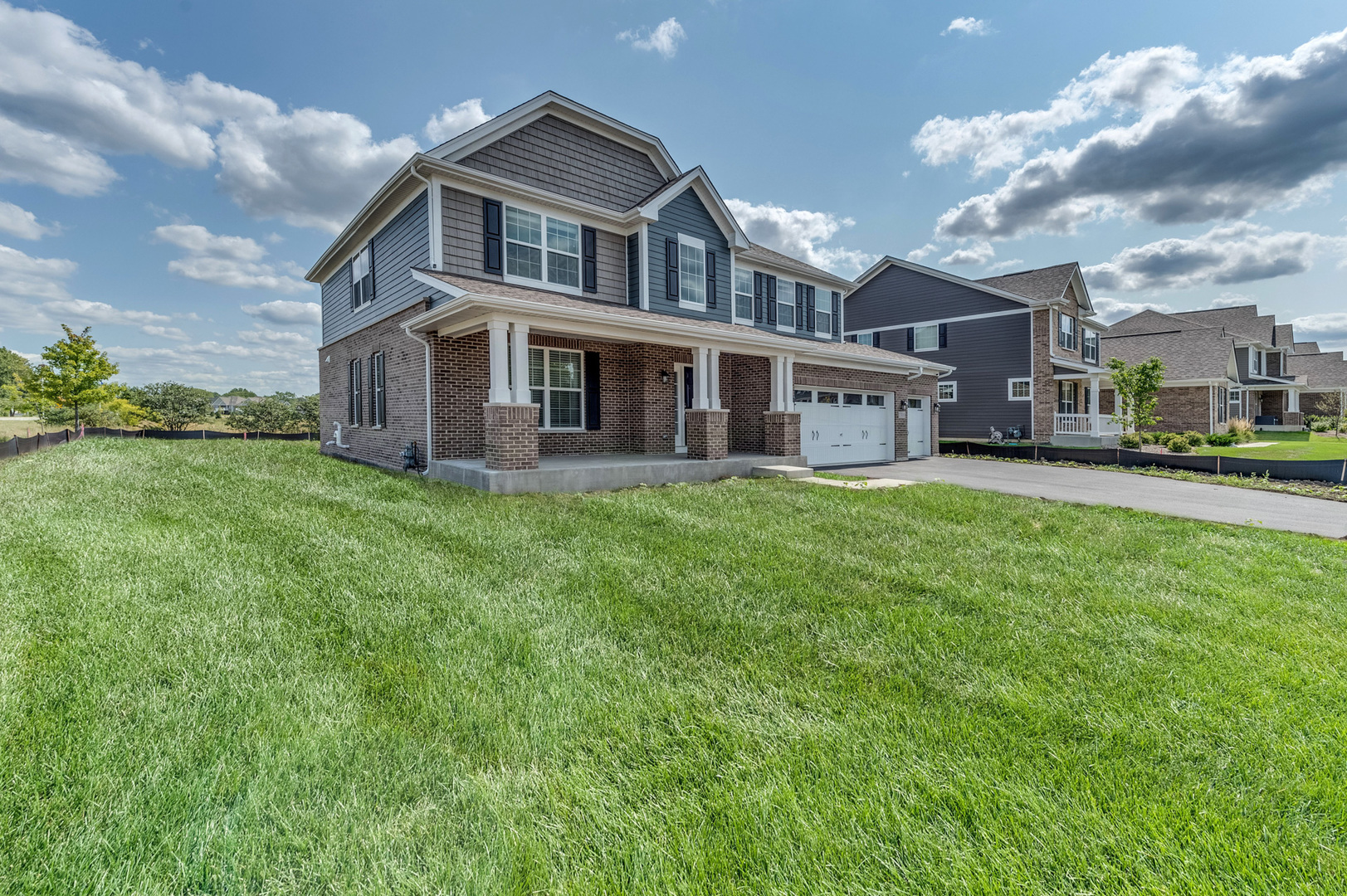 13101 Kettering Way Lemont, IL 60439 - Photo 2 of 36 a front view of a house with a yard