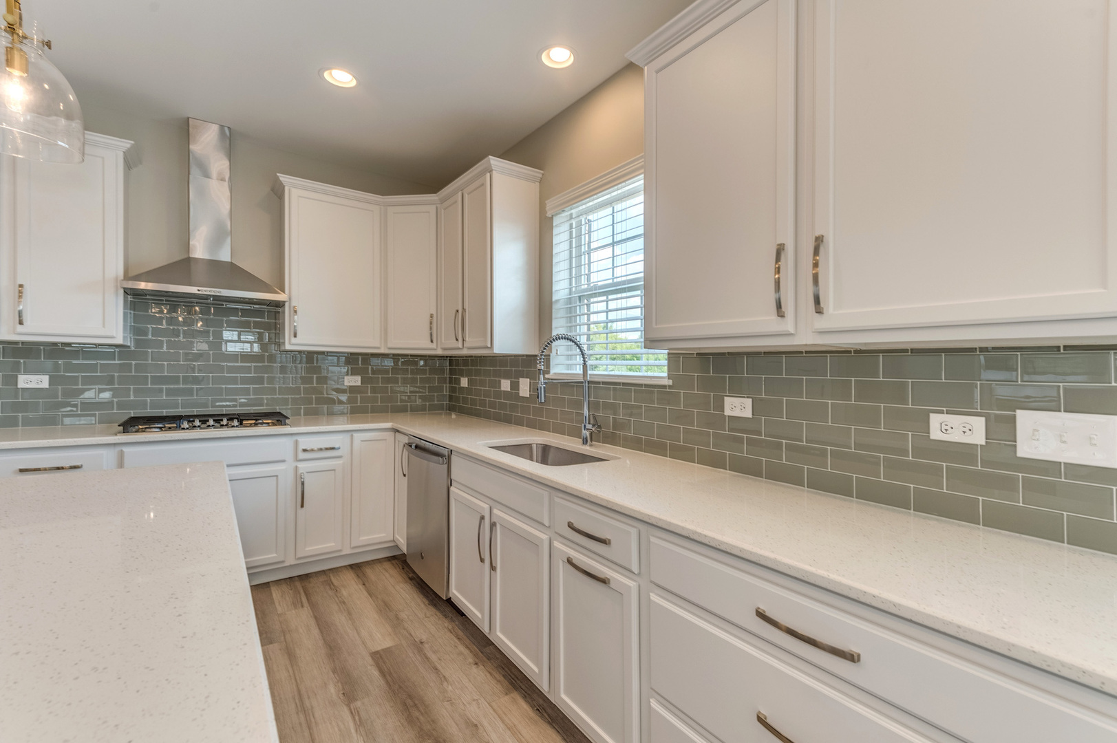 13101 Kettering Way Lemont, IL 60439 - Photo 12 of 36 a kitchen with white cabinets appliances a sink and a window