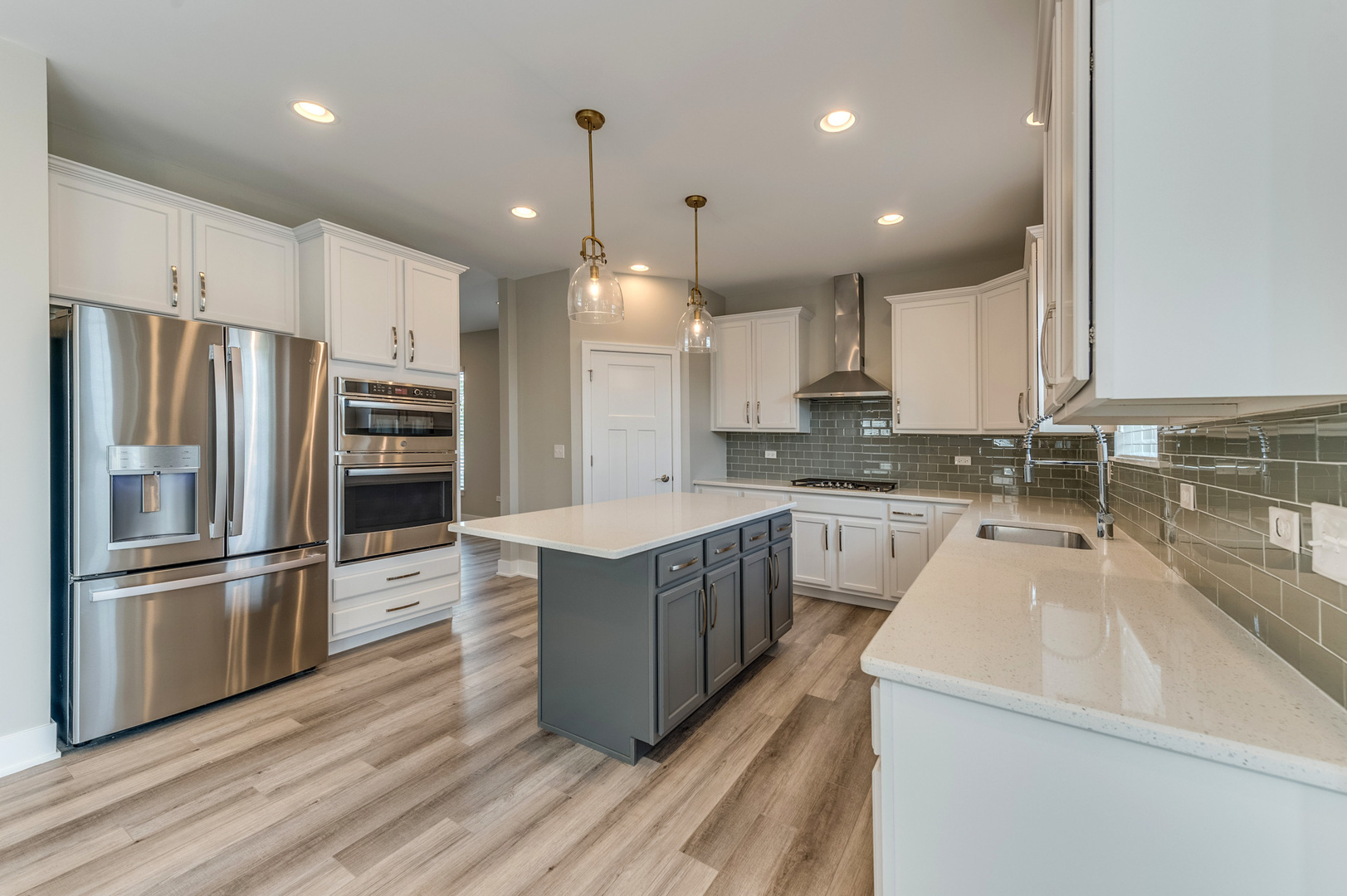 13101 Kettering Way Lemont, IL 60439 - Photo 13 of 36 a kitchen with stainless steel appliances granite countertop a refrigerator a sink dishwasher a oven and a dining table with wooden floor