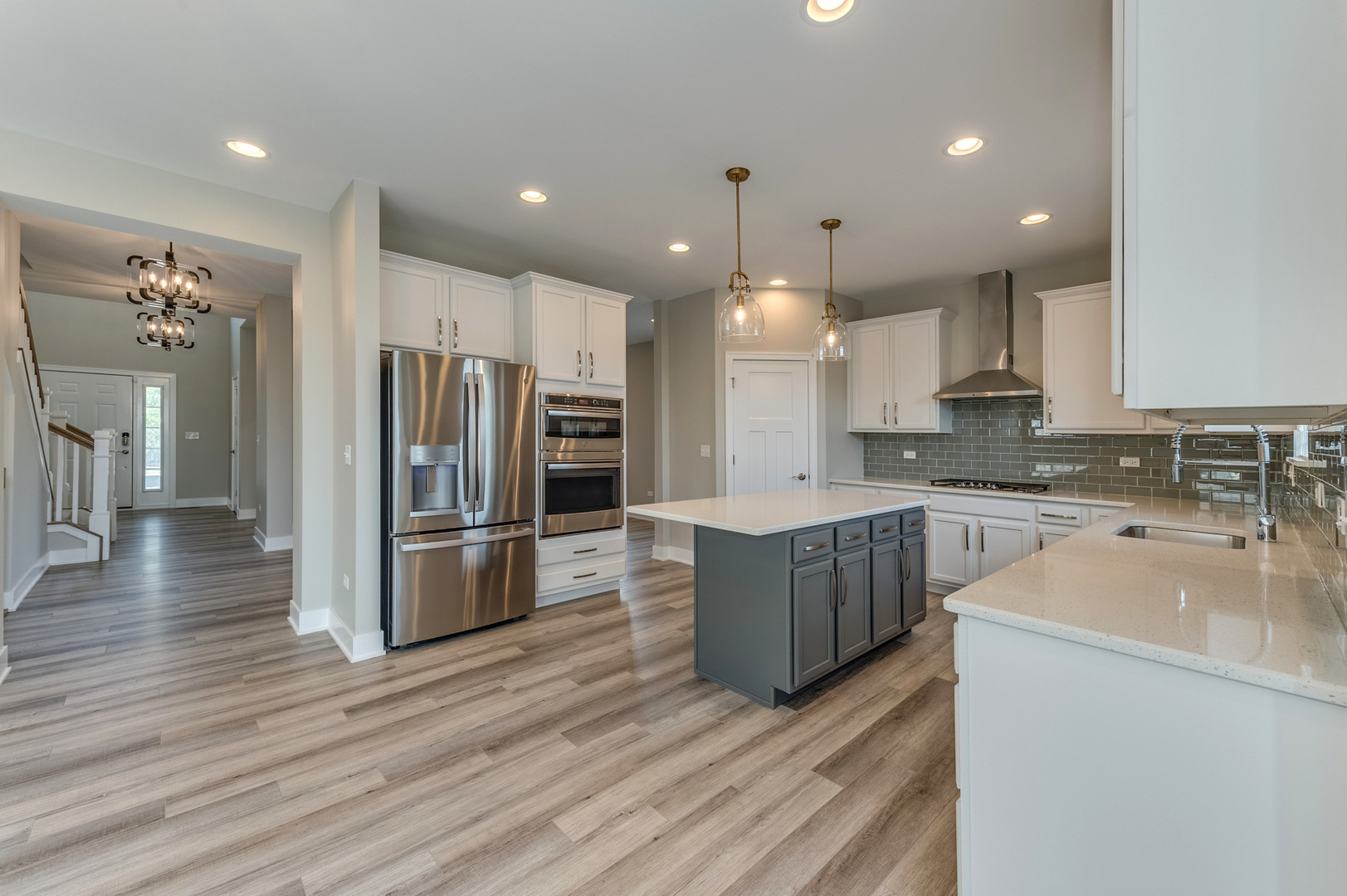 13101 Kettering Way Lemont, IL 60439 - Photo 14 of 36 a large kitchen with stainless steel appliances a refrigerator and a stove top oven