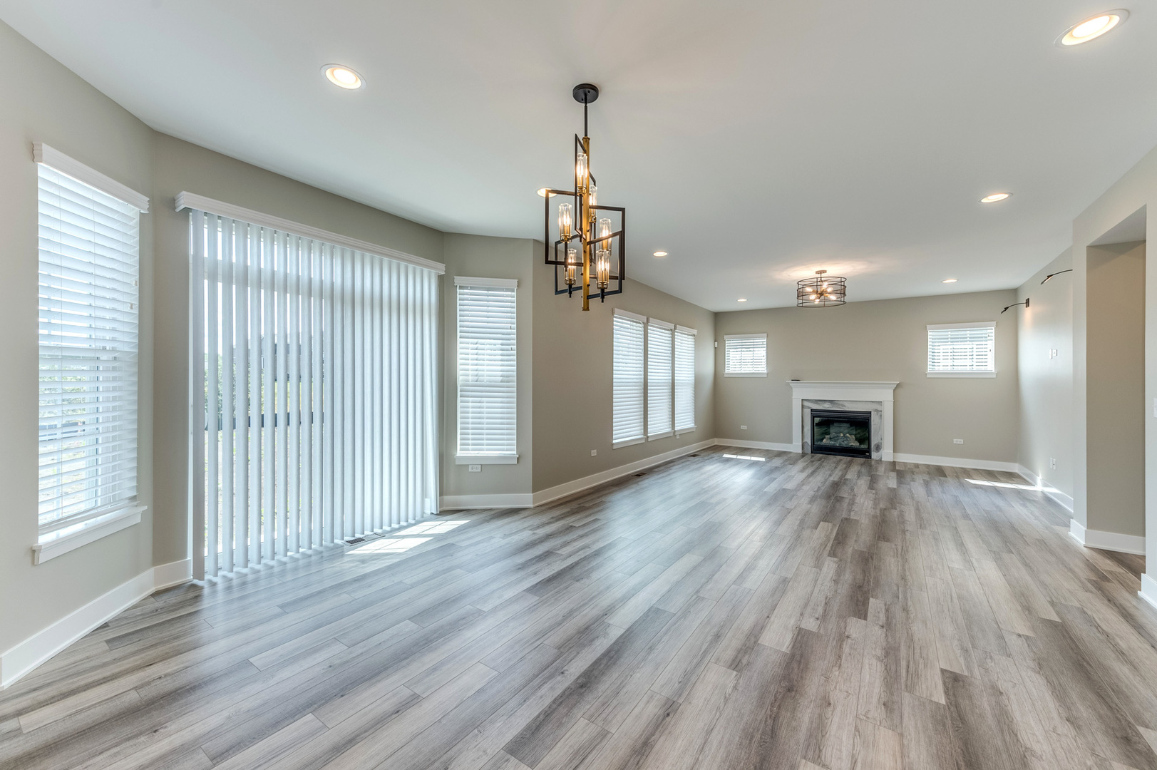 13101 Kettering Way Lemont, IL 60439 - Photo 16 of 36 a view of empty room with wooden floor and fireplace