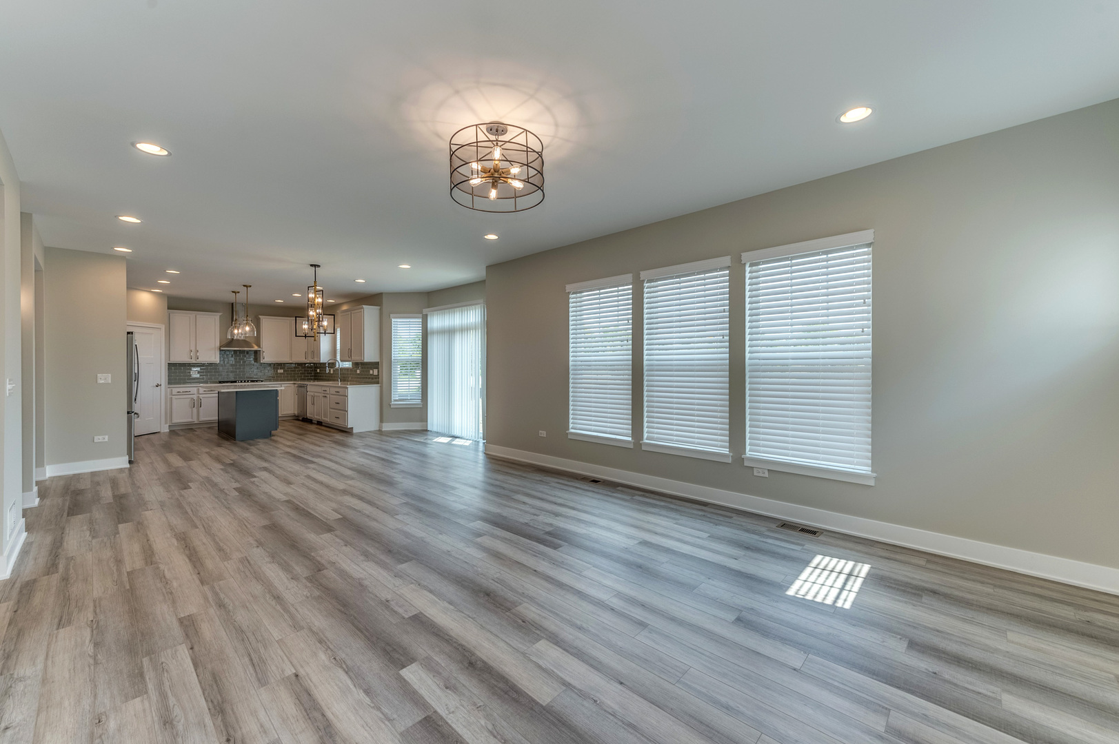 13101 Kettering Way Lemont, IL 60439 - Photo 18 of 36 a view of an empty room with a window and wooden floor
