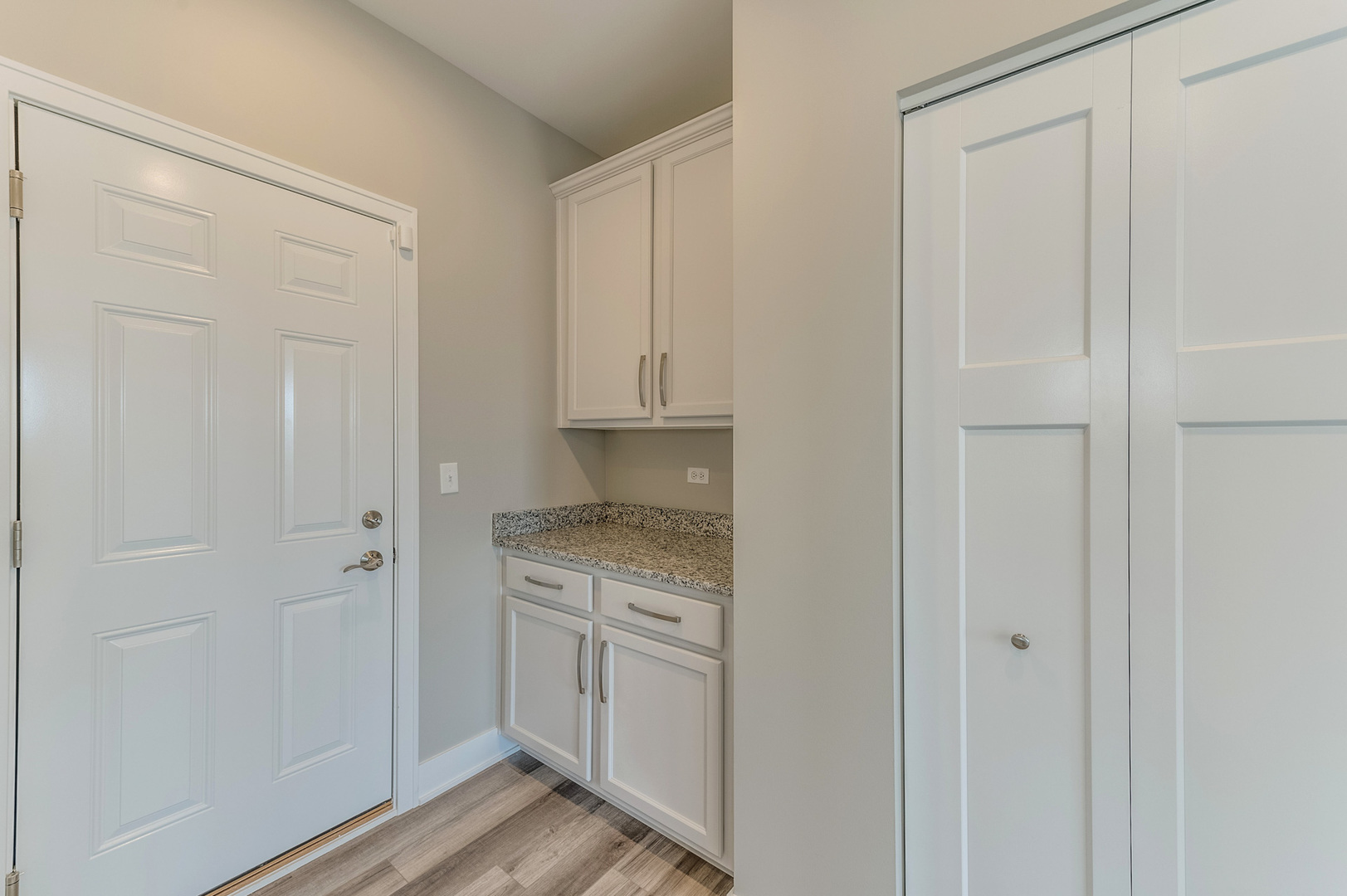 13101 Kettering Way Lemont, IL 60439 - Photo 21 of 36 a view of a kitchen with white cabinets and wooden floor