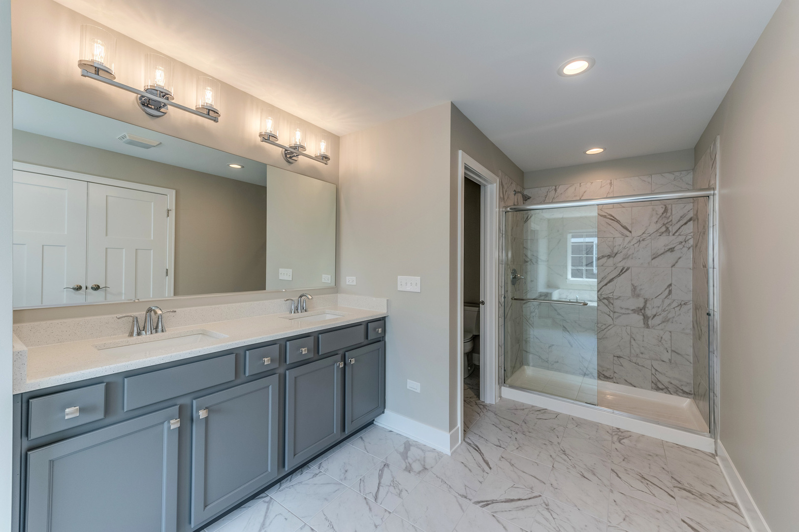 13101 Kettering Way Lemont, IL 60439 - Photo 27 of 36 a spacious bathroom with a shower a sink and mirror