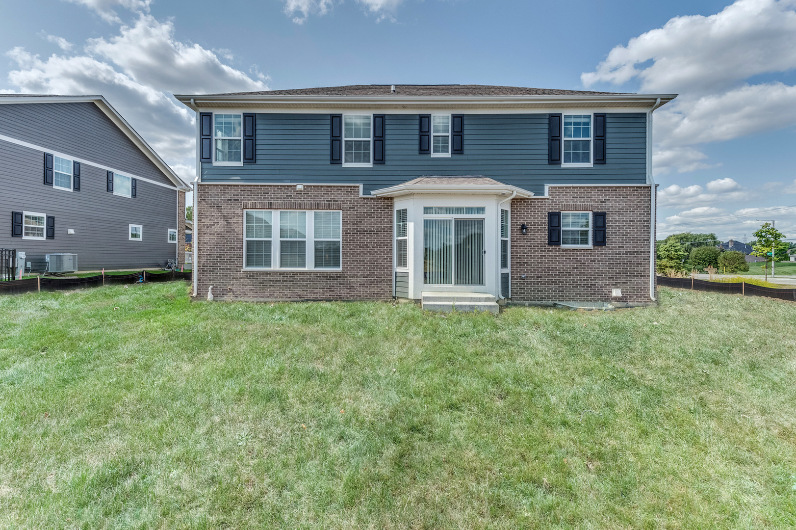 13101 Kettering Way Lemont, IL 60439 - Photo 36 of 36 a front view of a house with a yard and garage