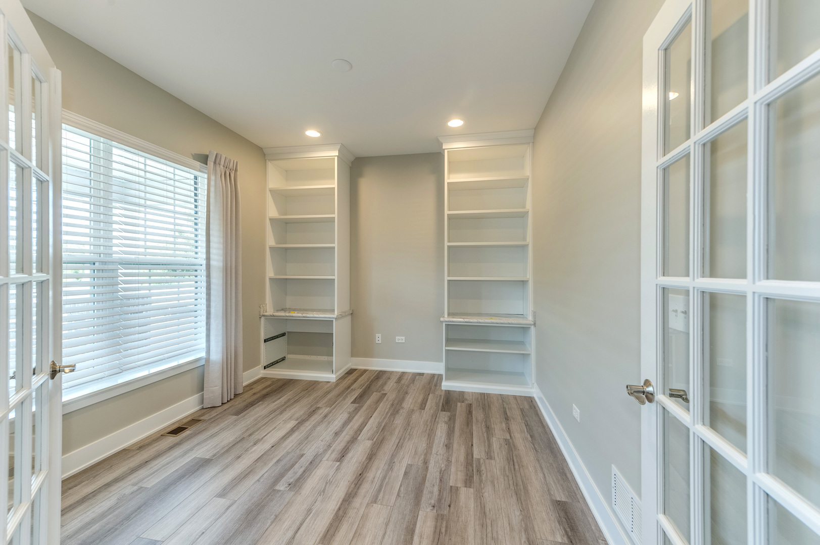 13101 Kettering Way Lemont, IL 60439 - Photo 7 of 36 a view of an empty room with a window and wooden floor