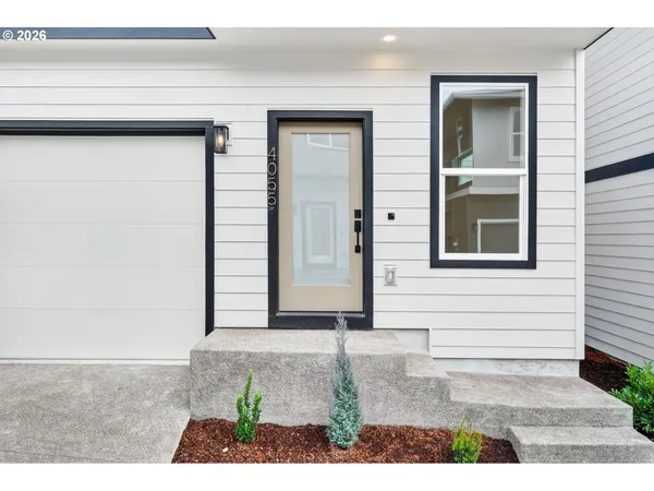 a view of a kitchen with refrigerator and white cabinets