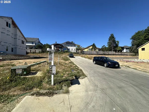 an aerial view of multi story residential apartment building with outdoor space and street view