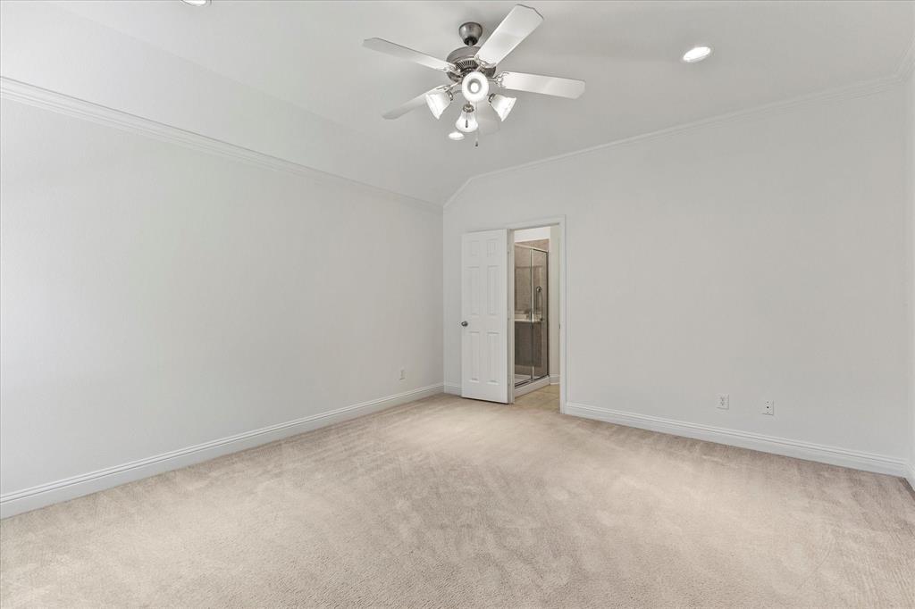 204 Tower Circle Terrell, TX 75160 - Photo 11 of 35 an empty room with a chandelier fan and windows