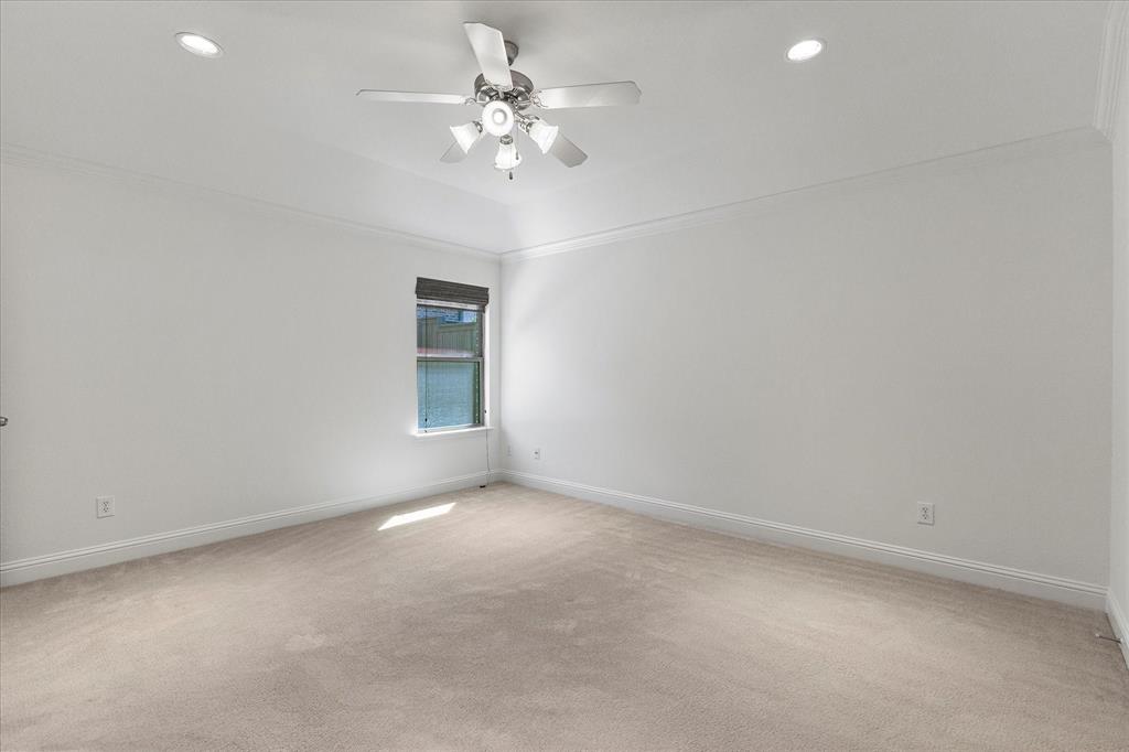 204 Tower Circle Terrell, TX 75160 - Photo 12 of 35 an empty room with a chandelier fan and windows