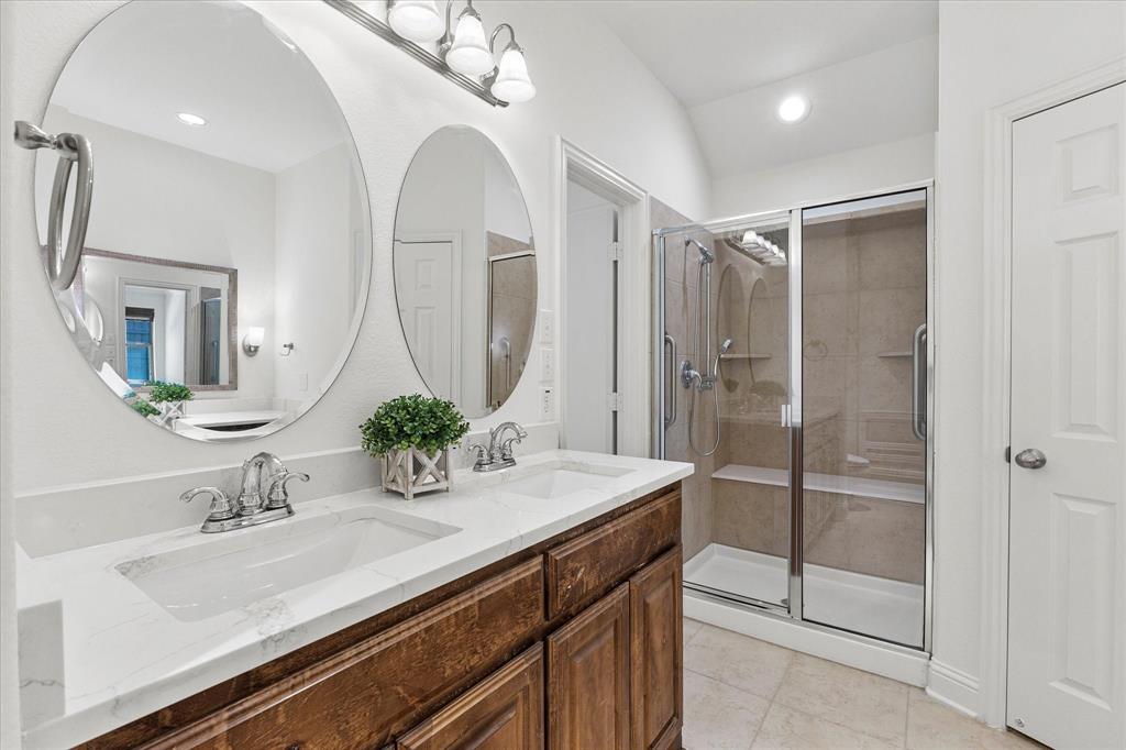 204 Tower Circle Terrell, TX 75160 - Photo 14 of 35 a bathroom with a sink a mirror and a shower
