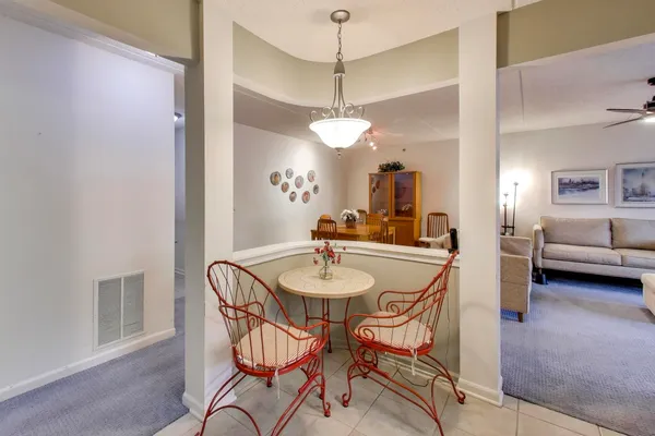 a dining room with furniture and a chandelier