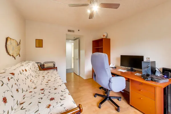 a bedroom with a bed and a desk