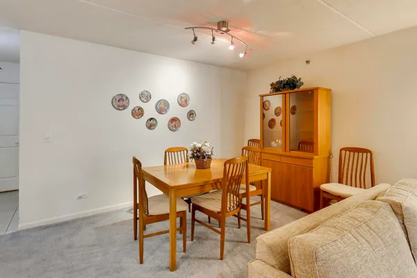 a dining room with furniture and wooden floor