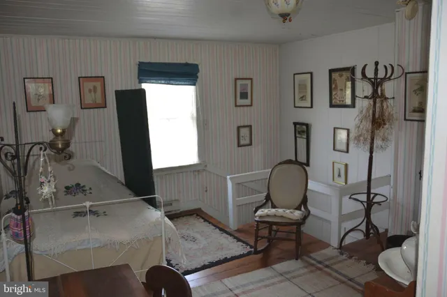 a bedroom with furniture and a rug