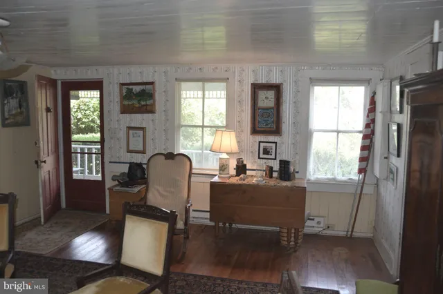 a view of a dining room with furniture and window
