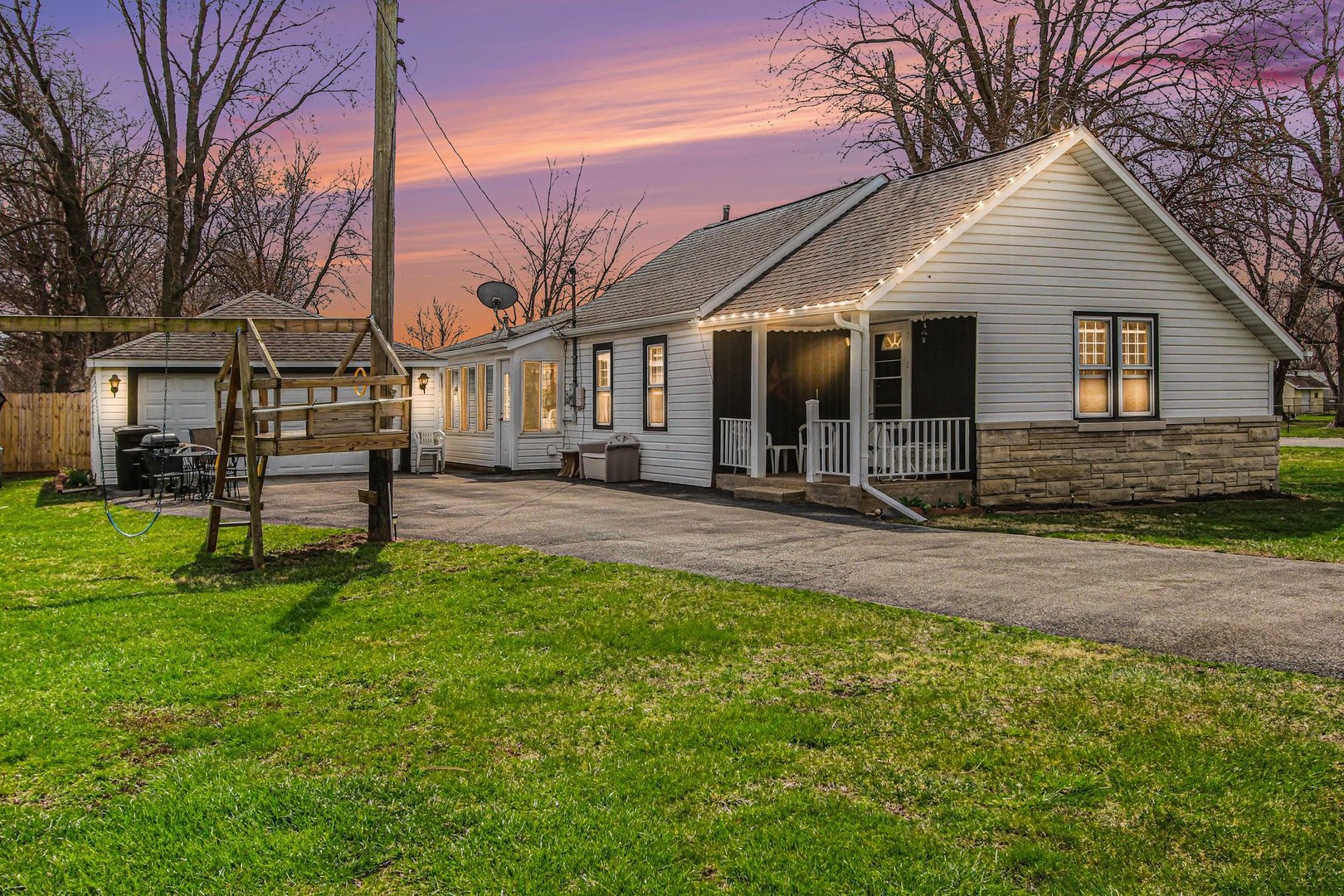 a front view of house with yard and green space