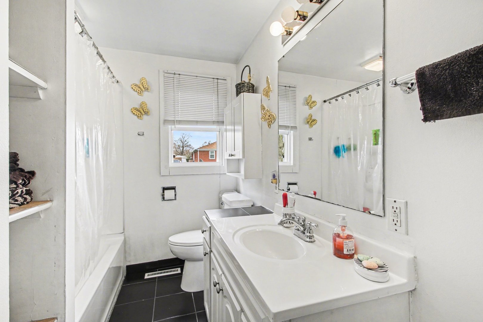 5335 Stone Avenue Portage, IN 46368 - Photo 12 of 17 a bathroom with a sink a toilet and shower curtain