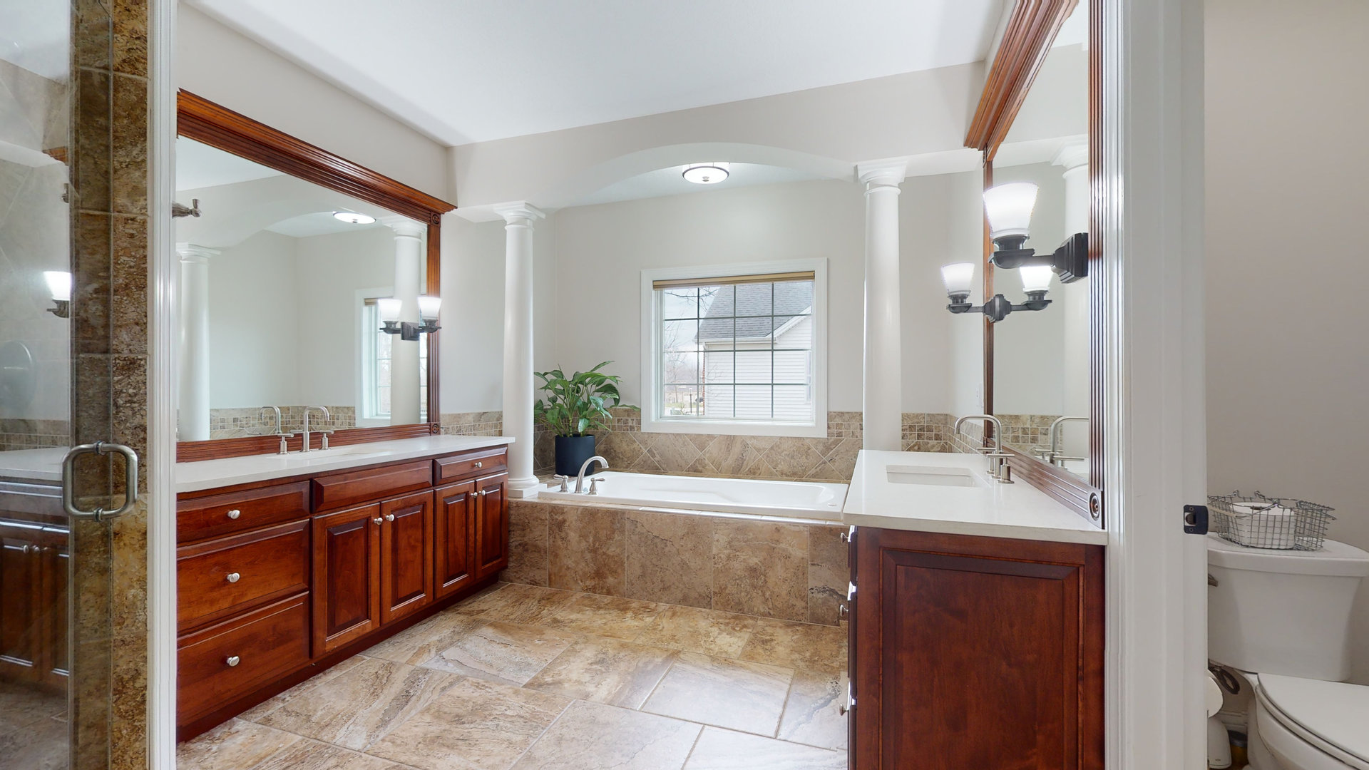 1303 East White Oak Road Mahomet, IL 61853 - Photo 20 of 64 a large bathroom with a double vanity sink a large mirror and a bathtub