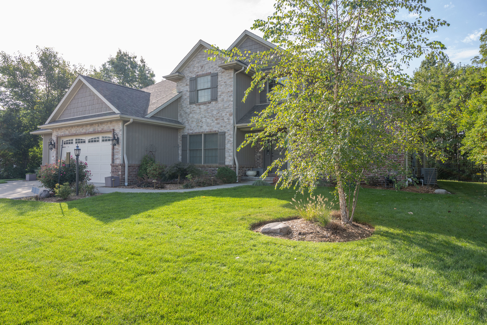 1303 East White Oak Road Mahomet, IL 61853 - Photo 2 of 64 a front view of a house with a yard
