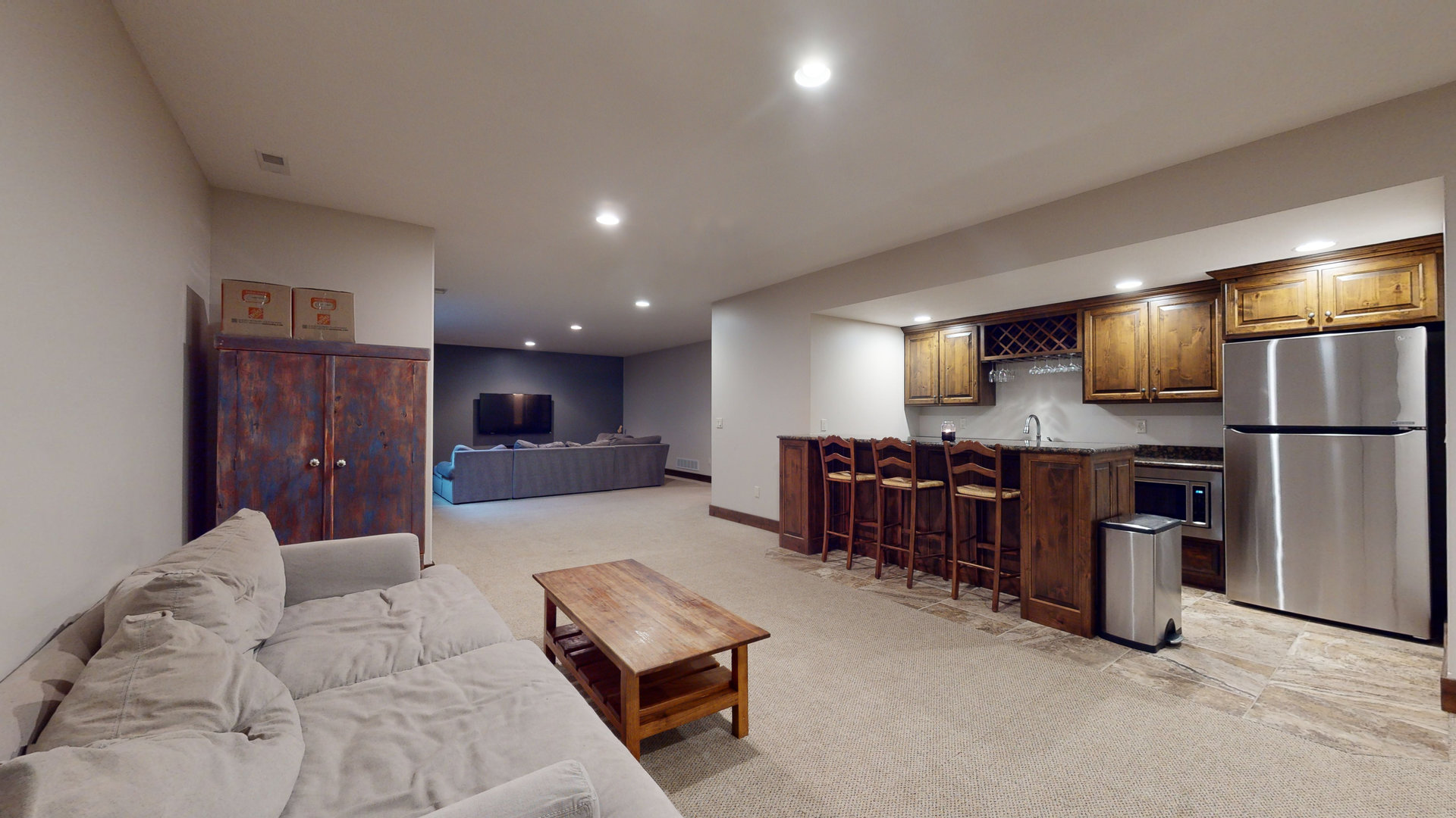 1303 East White Oak Road Mahomet, IL 61853 - Photo 38 of 64 a large living room with stainless steel appliances kitchen island granite countertop furniture and a large window