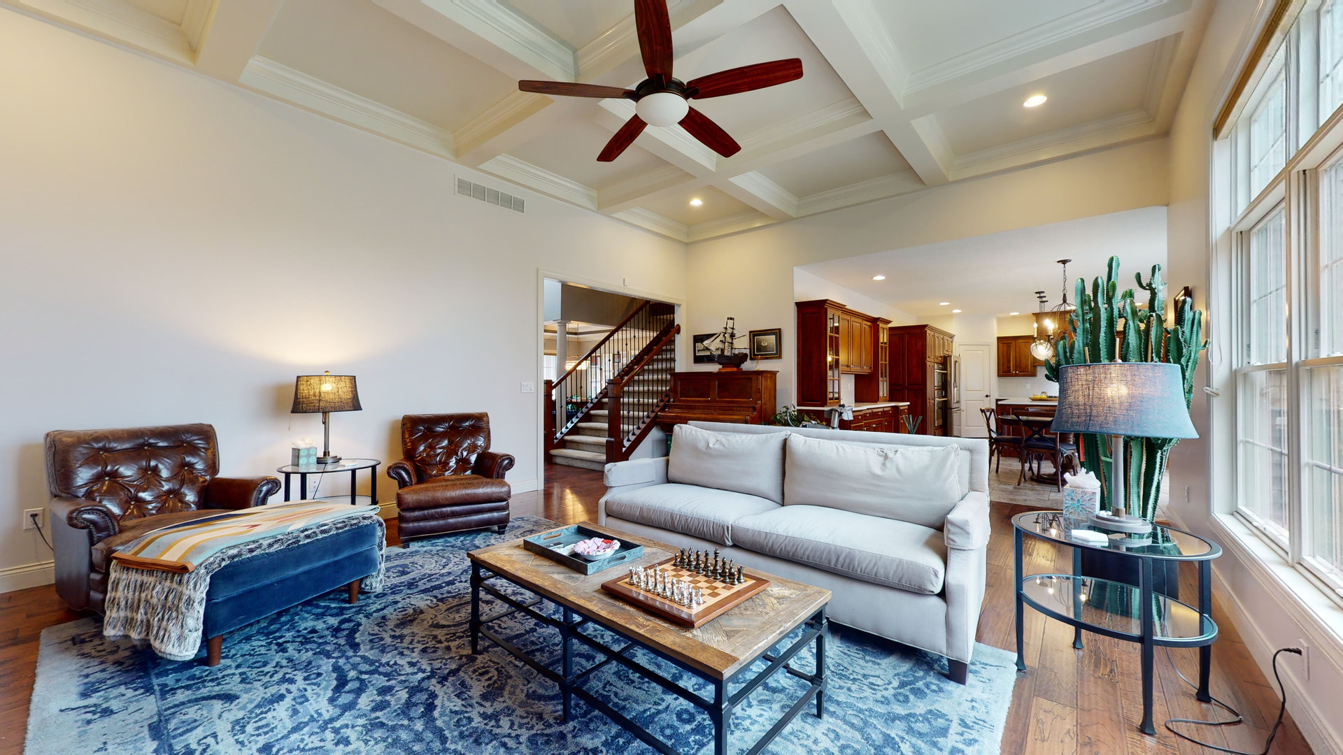 1303 East White Oak Road Mahomet, IL 61853 - Photo 4 of 64 a living room with furniture a rug and a chandelier