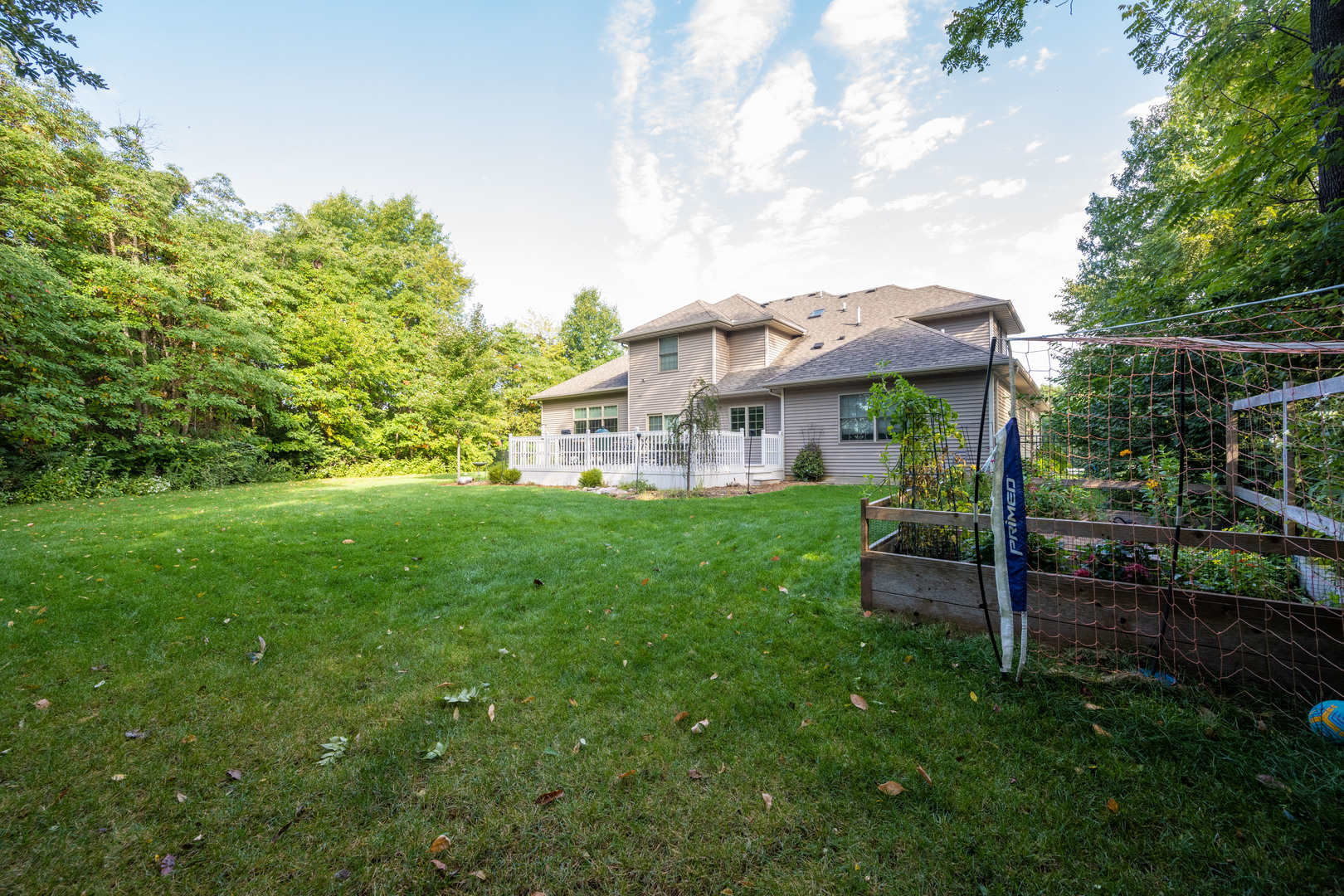 1303 East White Oak Road Mahomet, IL 61853 - Photo 57 of 64 a view of a house with a yard potted plants and a bench