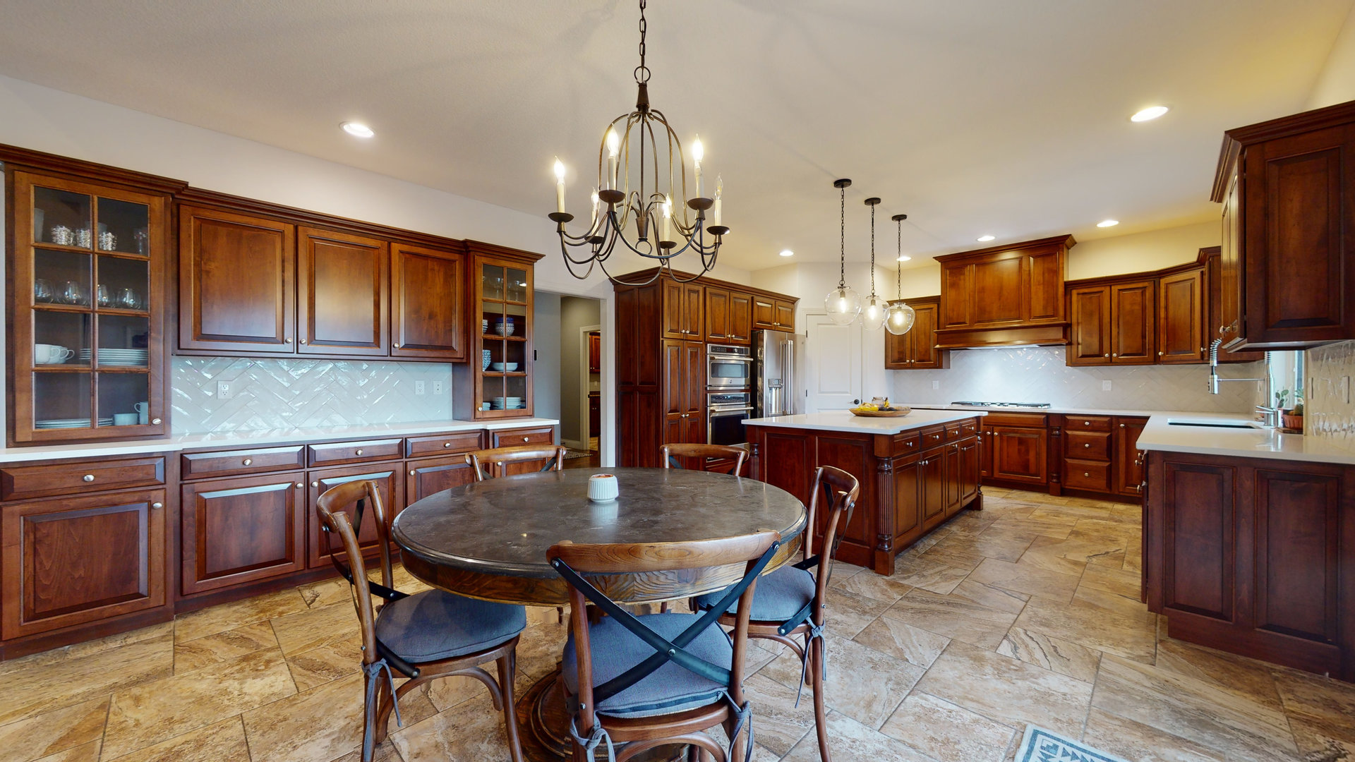 1303 East White Oak Road Mahomet, IL 61853 - Photo 8 of 64 a kitchen with stainless steel appliances granite countertop a stove a sink a microwave a center island and chairs