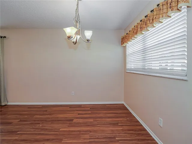 a view of a room with wooden floor and staircase