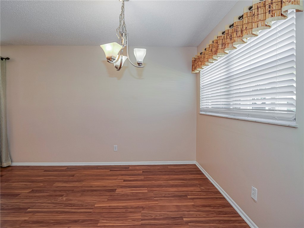 110 Spring Lake Court, Unit 102 Vero Beach, FL 32962 - Photo 12 of 33 a view of a room with wooden floor and staircase