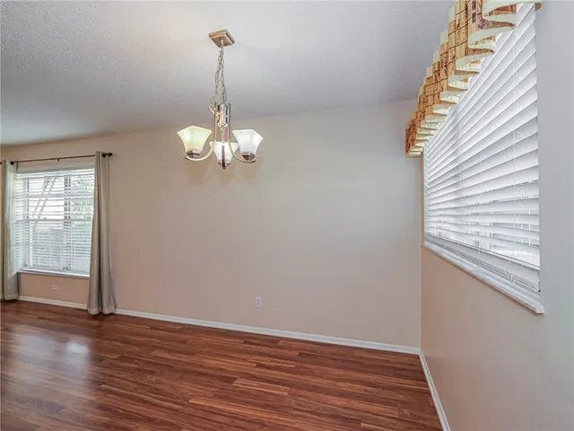 a view of a room with wooden floor and window