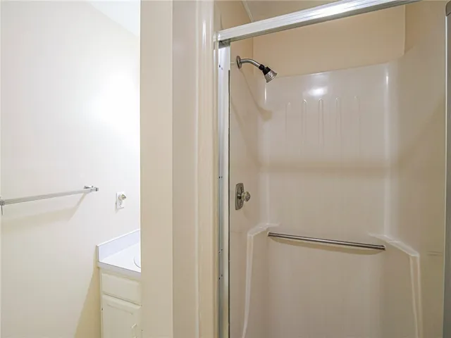 a bathroom with a glass shower door