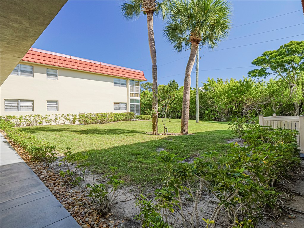110 Spring Lake Court, Unit 102 Vero Beach, FL 32962 - Photo 2 of 33 a view of a house with garden and a tree