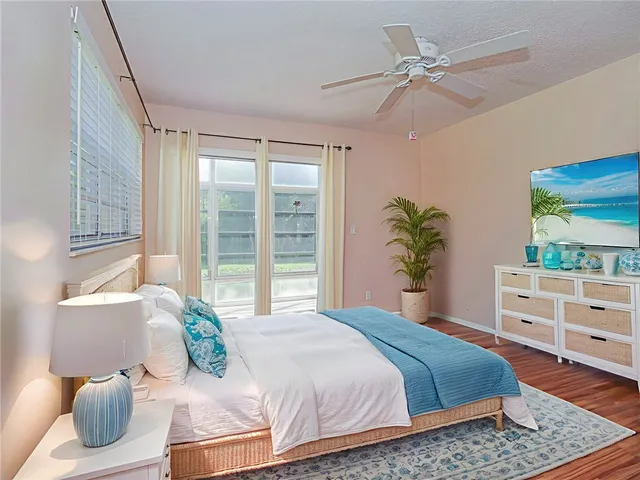 a bedroom with a bed and dresser with mirror