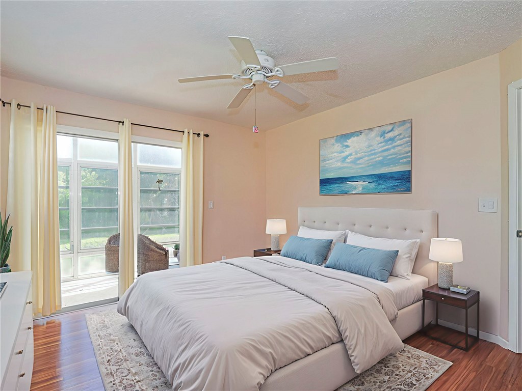 110 Spring Lake Court, Unit 102 Vero Beach, FL 32962 - Photo 23 of 33 a bedroom with a large bed and a window