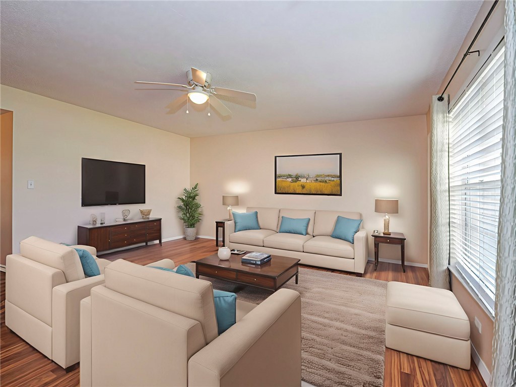 110 Spring Lake Court, Unit 102 Vero Beach, FL 32962 - Photo 5 of 33 a living room with furniture and a flat screen tv