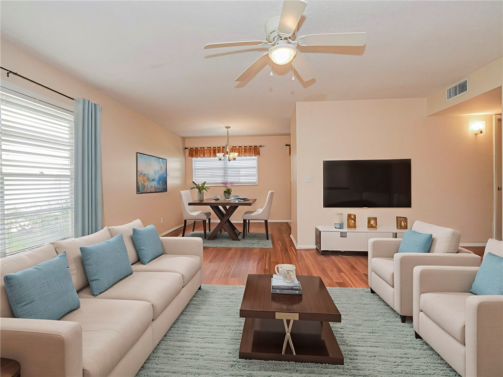 110 Spring Lake Court, Unit 102 Vero Beach, FL 32962 - Photo 7 of 33 a living room with furniture and a flat screen tv