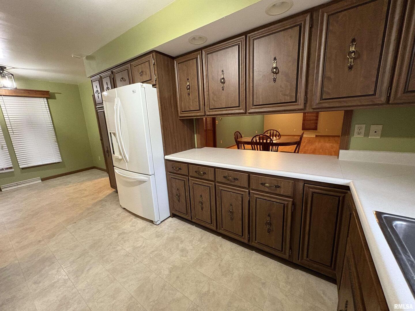 623 Meadowbrook Lane Centralia, IL 62801 - Photo 8 of 16 a kitchen with refrigerator and cabinets