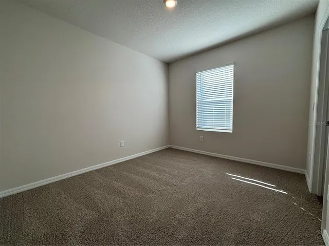 an empty room with windows and entrance