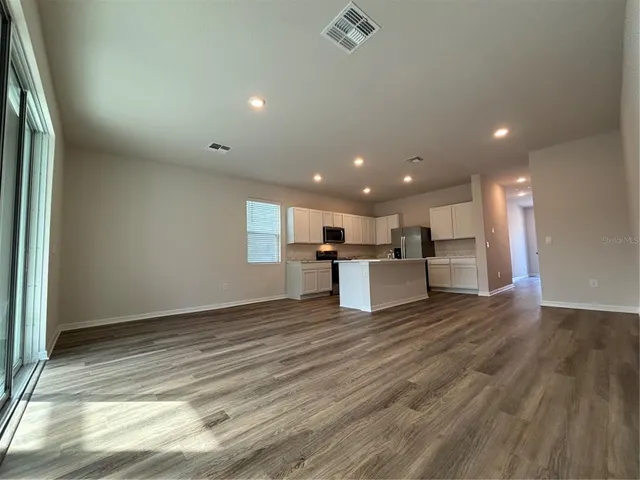 a view of a hallway with a wooden floor