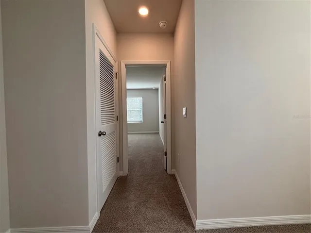 a view of kitchen with wooden floor and electronic appliances