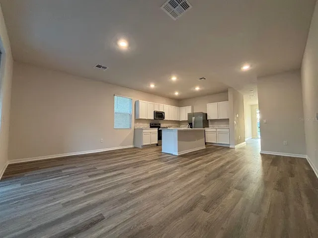a view of kitchen with wooden floor